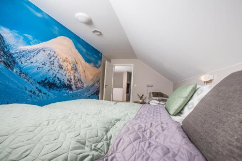 a bedroom with a large bed with a mountain mural at Intersporthytta Sogndal in Sogndal