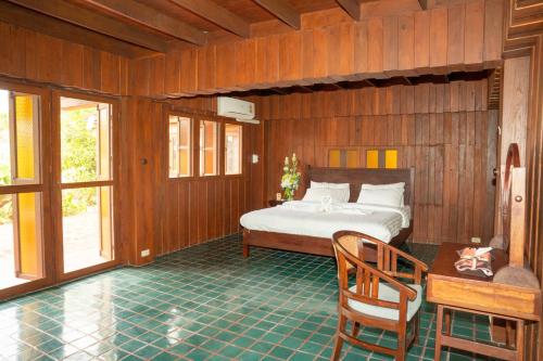a bedroom with a bed and a table and chairs at Stay At Lantana Mae Rim in Ban Pa Muang