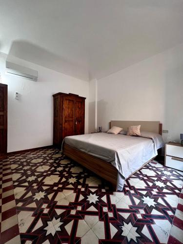 a bedroom with a large bed and a patterned floor at Kali' in Rapallo