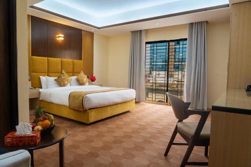 a hotel room with a large bed and a window at Crystal Heritage Inn in Dhaka