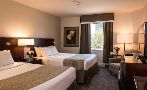 Ένα ή περισσότερα κρεβάτια σε δωμάτιο στο Lord Elgin Hotel