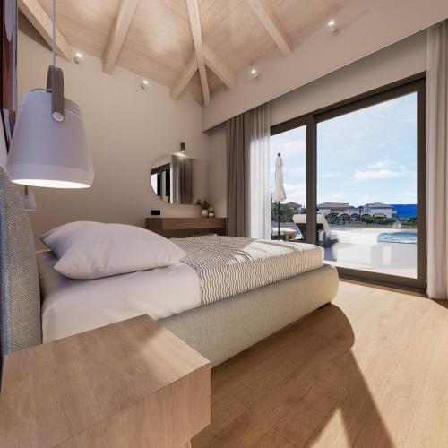 a bedroom with a bed with a view of the ocean at Villa Morena in Kypseli