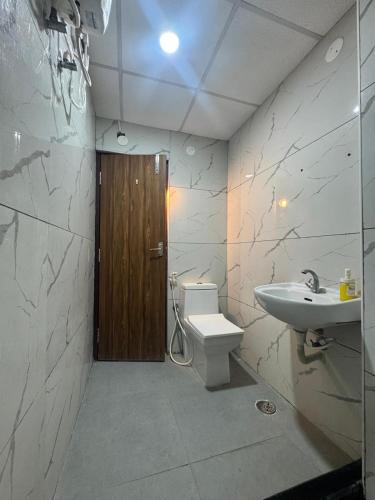 a bathroom with a toilet and a sink at Premium 2BHK Apartment by Key Stays - Hyd in Hyderabad