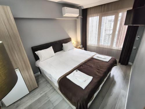 a small bedroom with a bed in a room at Sun Suites in Istanbul