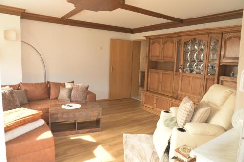 a living room with a couch and a table at Appartement Naunspitzblick in Ebbs