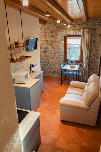 a living room with a couch and a table at Corte d'Arnosto - Casa Virginia in Fuipiano Valle Imagna