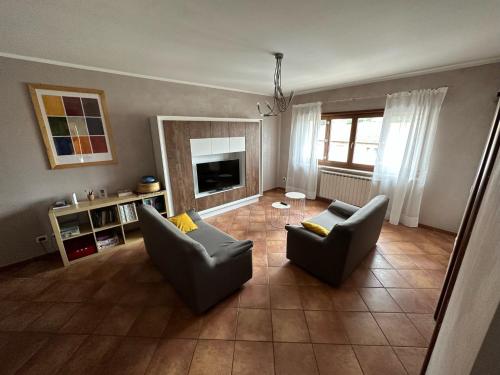 a living room with two chairs and a fireplace at Casa Montessori in Avezzano