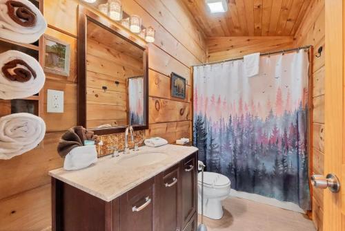 a bathroom with a sink and a shower in a cabin at Holy Smokes in Townsend