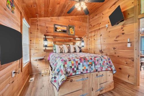 a bedroom with a bed in a room with wooden walls at Holy Smokes in Townsend
