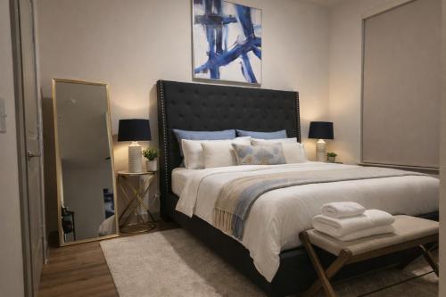 a bedroom with a large bed and a mirror at Modern King Bed Unit with Arcade at The Vic Walk to Midtown Downtown in Houston