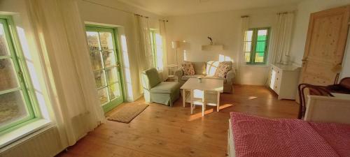 a living room with a couch and a table at Hof Rodenkrog in Lütjenburg