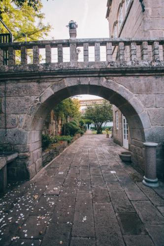 an old stone bridge over a brick road at Pazo Santa Teresa in Redondela