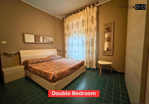a bedroom with a bed and a table in it at Bergeggi - Appartamento Fronte Mare in Bergeggi