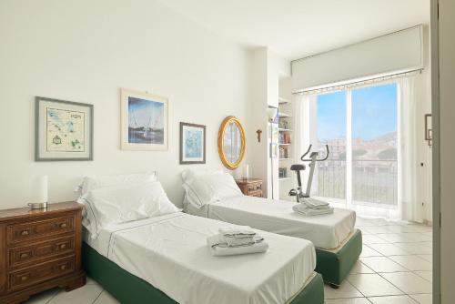 a bedroom with two beds and a window at SottoVento in Imperia