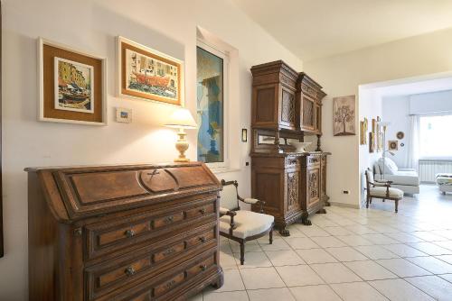a room with a large wooden dresser and a living room at SottoVento in Imperia