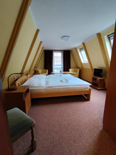 a bedroom with a large bed in a room at Hotel Loucky in Litvínov