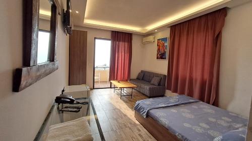 a small room with a bed and a couch at Byblos inn, jbeil ,Fidar in Al Fīdār