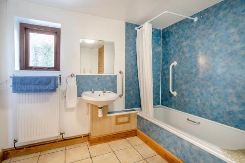 a bathroom with a tub and a sink and a shower at 2 Bed in Risca oc-b35977 in Risca