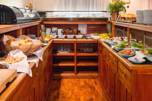 a kitchen with many plates of food on the counters at Hotel Aviv Dresden in Dresden