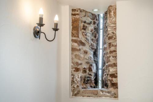 a light on a wall next to a brick wall at 2 Bed in Risca oc-h35978 in Risca