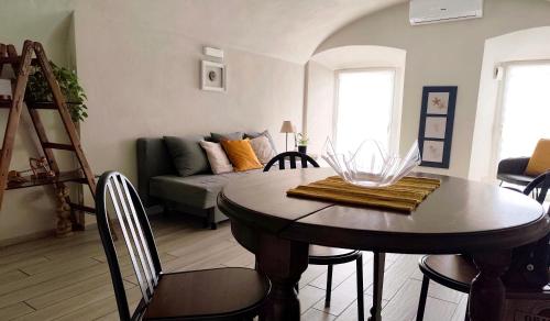 a living room with a table and a couch at Nene's Home in Sanremo