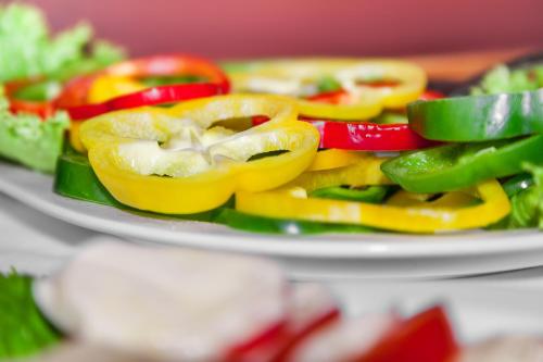 a plate of peppers and vegetables on a table at Hotel Aviv Dresden in Dresden