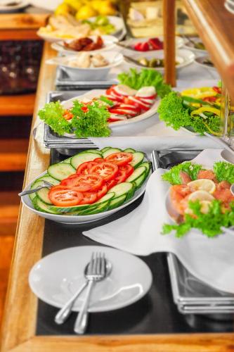 a buffet with plates of food on a table at Hotel Aviv Dresden in Dresden