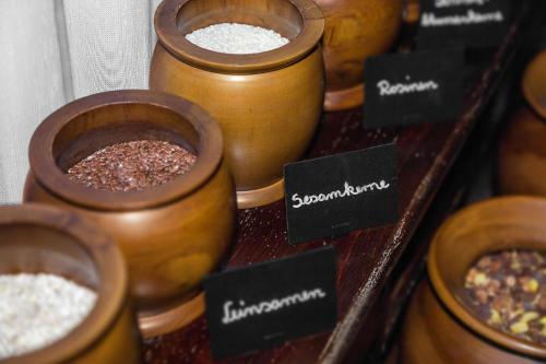a group of wooden bowls filled with different types of food at Hotel Aviv Dresden in Dresden