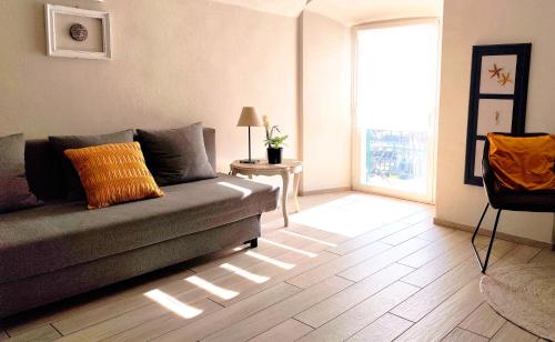 a living room with a couch and a window at Nene's Home in Sanremo