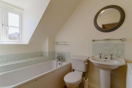 a bathroom with a sink and a toilet and a bath tub at 3 Bed in Reydon oc-a36049 in Reydon