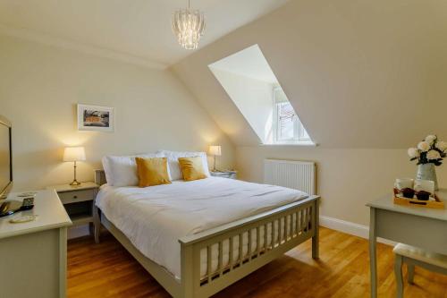 a bedroom with a large bed in a attic at 3 Bed in Reydon oc-a36049 in Reydon