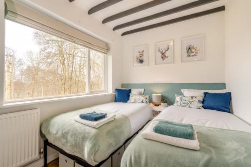 two beds in a room with a window at 2 Bed in Beaconsfield oc-t35951 in Beaconsfield