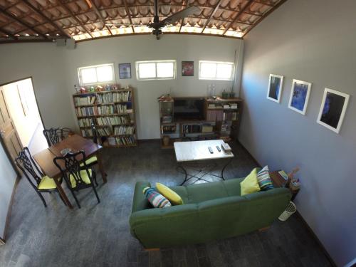 einen Blick über ein Wohnzimmer mit grüner Couch in der Unterkunft Pousada Orla do Sol in Prado