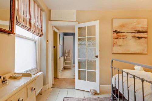 a bedroom with a bed and a door to a hallway at 3 Bed in Appledore oc-t28375 in Appledore