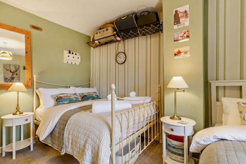 a bedroom with two beds and a mirror at 3 Bed in Appledore oc-t28375 in Appledore