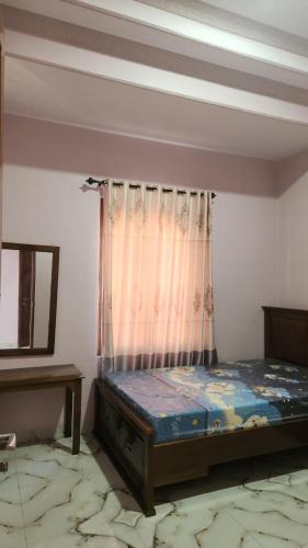 a bedroom with a bed in a room with a window at Velora Inn in Jakarta
