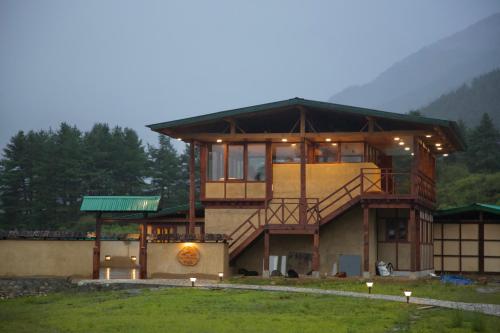 a large house with a staircase in front of it at Haa Valley Camp in Kechungka