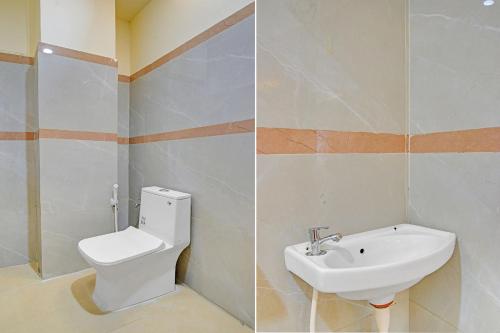 a bathroom with a toilet and a sink at FabHotel SV Grand in Hyderabad