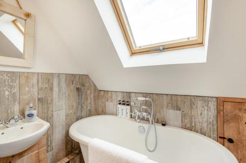 a bathroom with a white tub and a sink at 3 Bed in Tenterden oc-p36303 in Tenterden