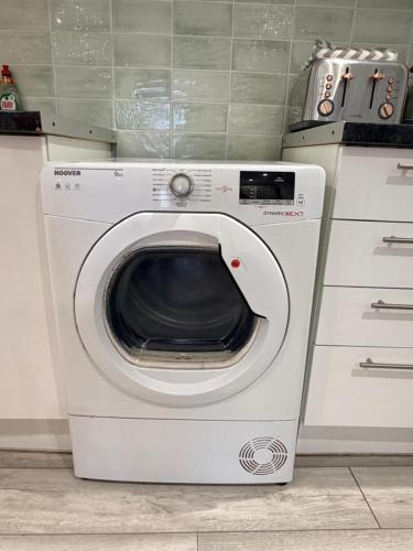a washer and dryer sitting in a kitchen at Modern Studio in Newport City Centre Free Parking & WiFi Sleeps 2 in Newport