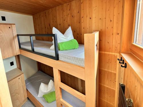 a room with two bunk beds in a cabin at Abenteuer Turm in Braunwald