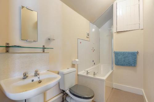 a white bathroom with a sink and a toilet at 2 Bed in Hastingleigh oc-c36343 in Hastingleigh