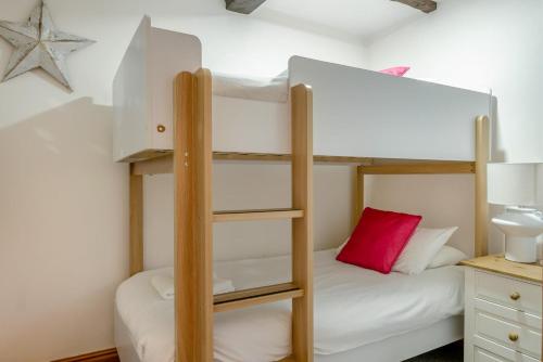a bedroom with two bunk beds with a red pillow at 3 Bed in Shanklin oc-b36038 in Shanklin