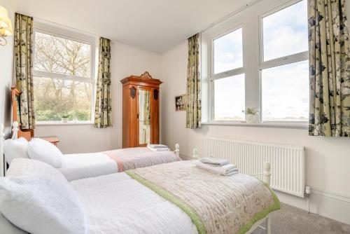 two beds in a room with two windows at 2 Bed in Shepley oc-c36884 in Shepley