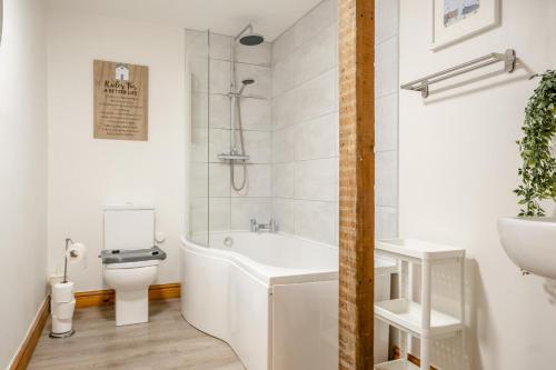 a bathroom with a tub and a toilet and a sink at 3 Bed in Shanklin oc-b36038 in Shanklin