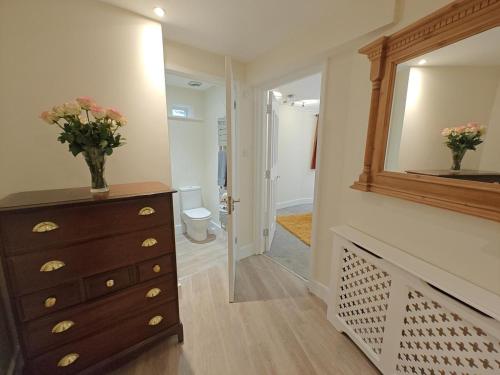 a bathroom with a dresser and a mirror at 1 Bed in Hexham oc-g37537 in Hexham