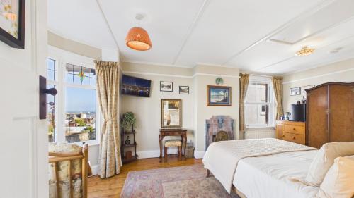 a bedroom with a bed and a large window at Room with a View at Anchor Down Cottage in Ryde