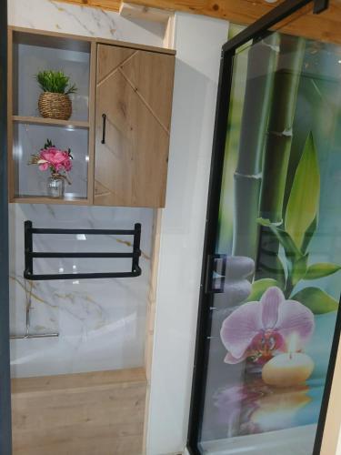 a room with a glass door with a plant in it at Gite et Studio "L'éclosion des Papillons" à 10 kms de Lens in Courrières