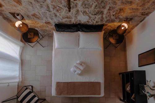 a bedroom with a bed with two white pillows at Lilian Horizon in Tolo