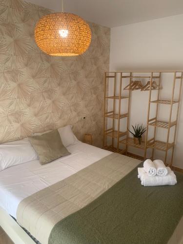 a bedroom with a bed with towels on it at Apartament Lo Passador in Deltebre